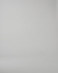 A woman modeling a long sleeve floral dress on a white studio background