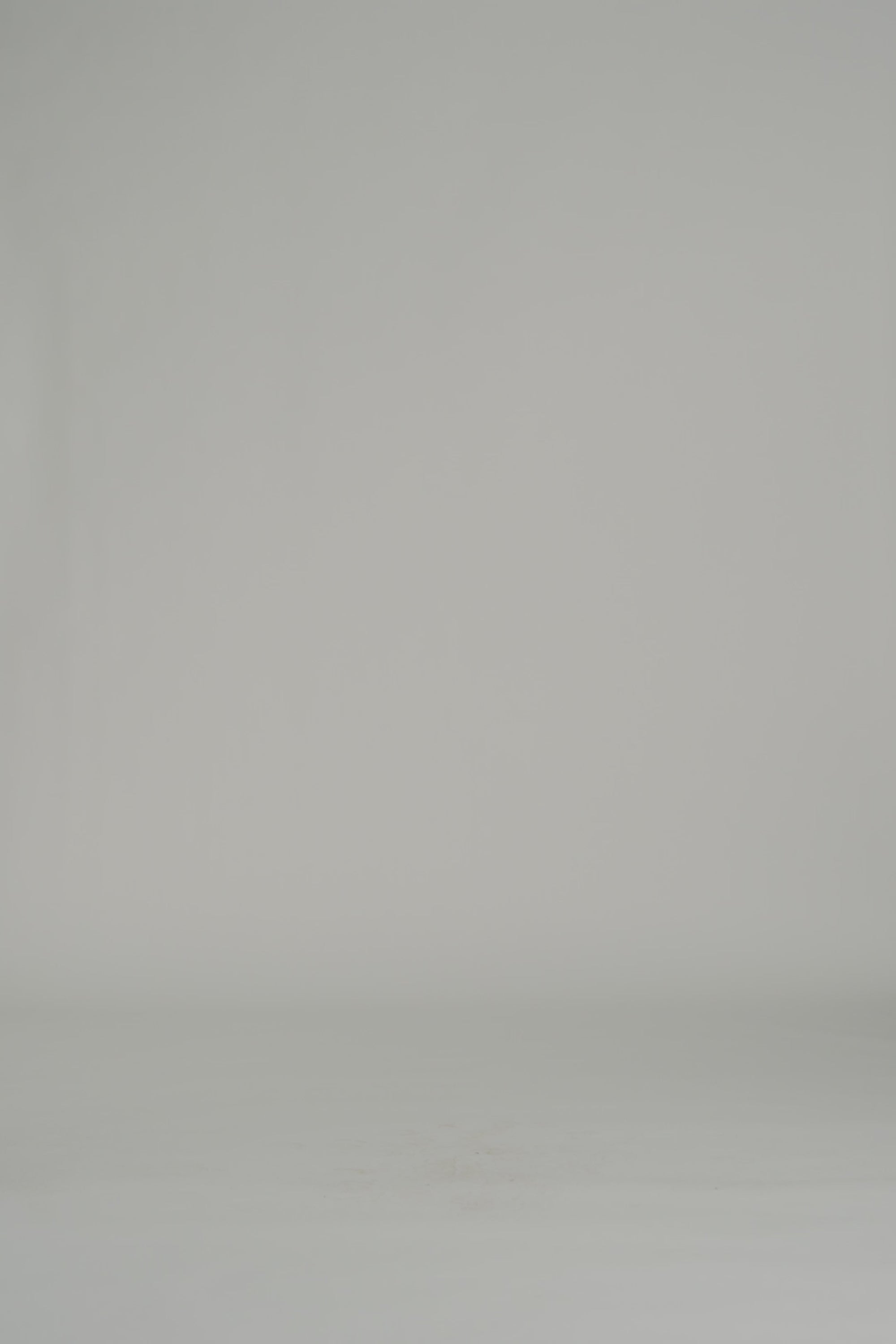 woman modeling a white long sleeve maxi dress on a white backdrop