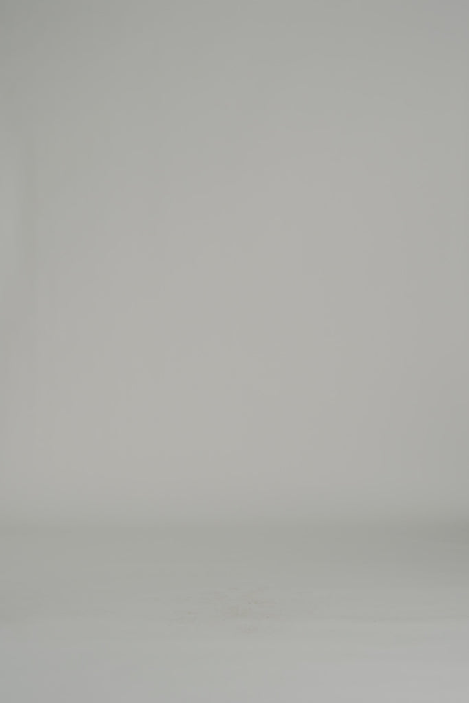 woman modeling a white long sleeve maxi dress on a white backdrop