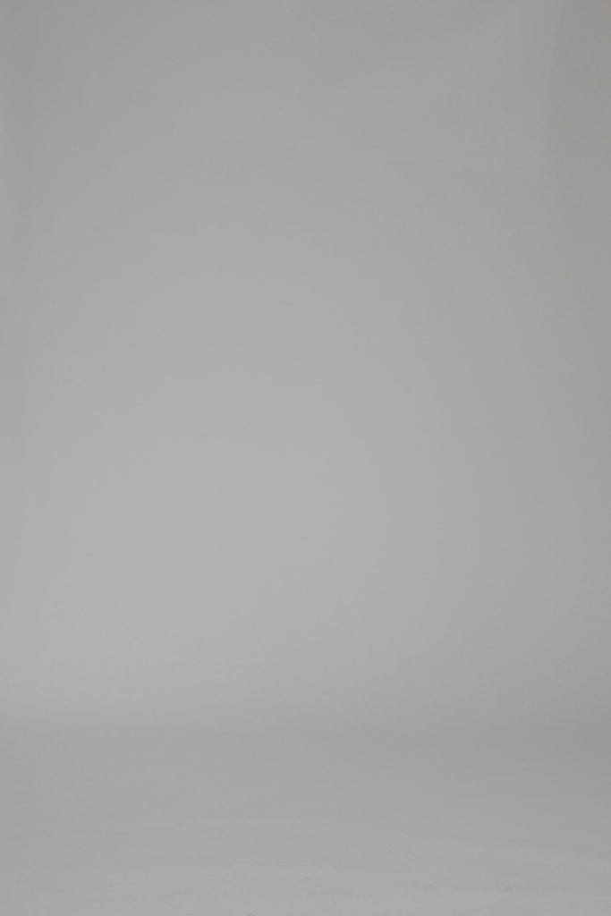 Woman modeling a blue and white striped long sleeve dress on a white backdrop