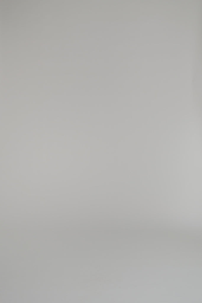 woman modeling a red cashmere polo against a white backdrop