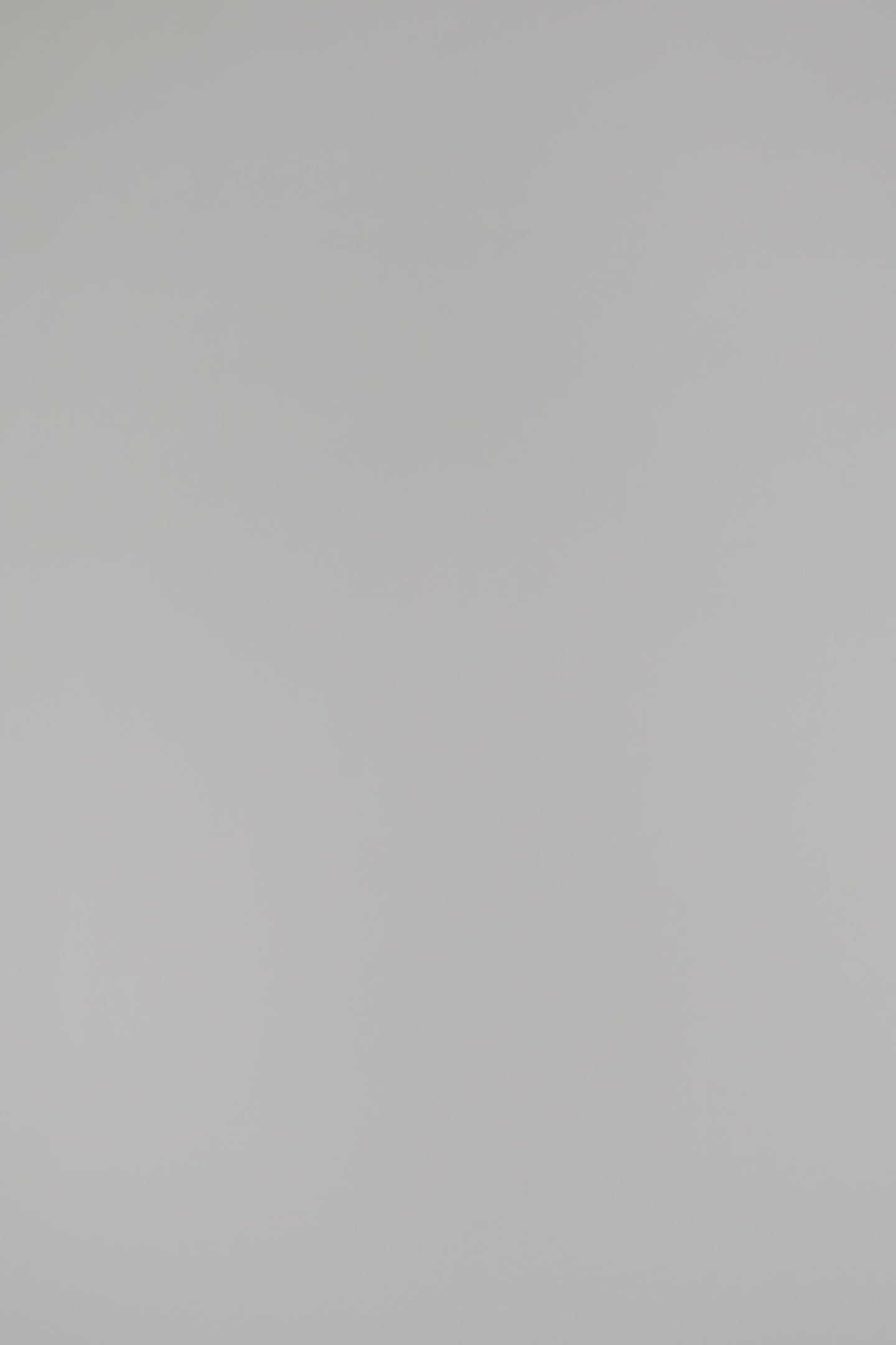 woman modeling a black cashmere shell on a white background