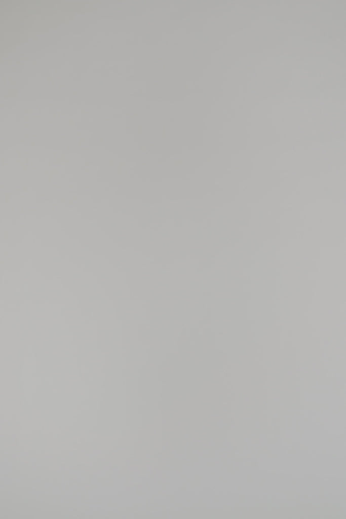 woman modeling a black cashmere shell on a white background