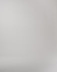 video of a woman wearing a pleated skirt set walking across a white background