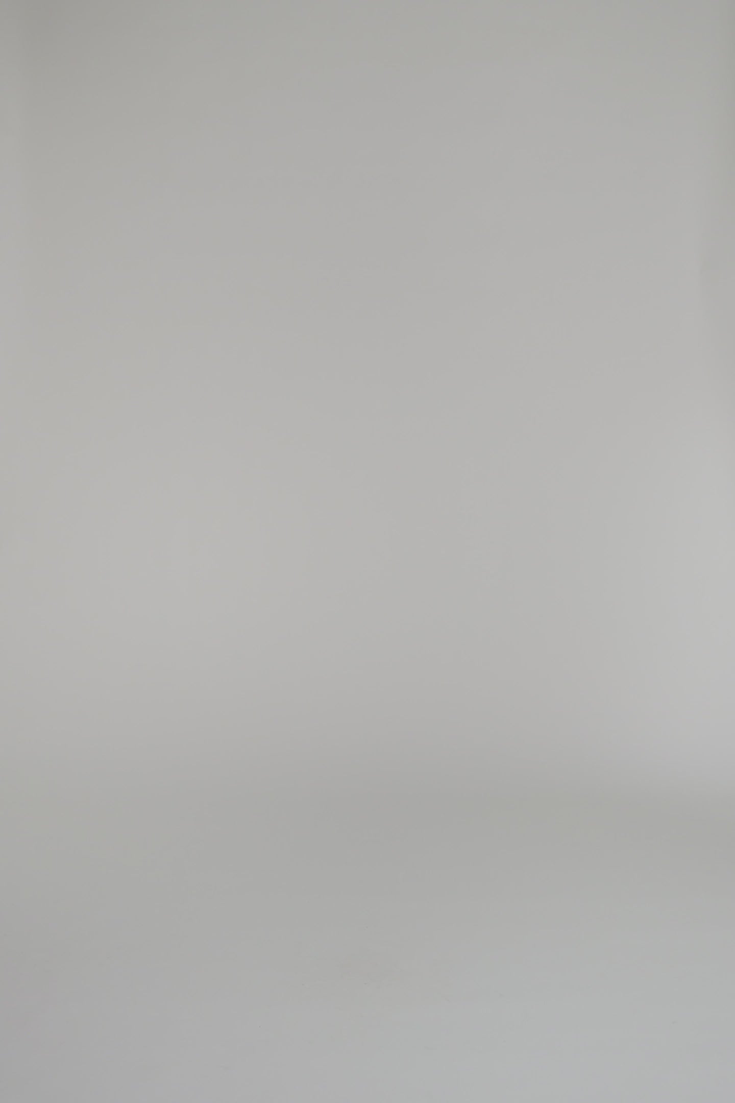 woman wearing merlot knit dress against a white backdrop