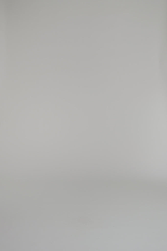 woman wearing merlot knit dress against a white backdrop