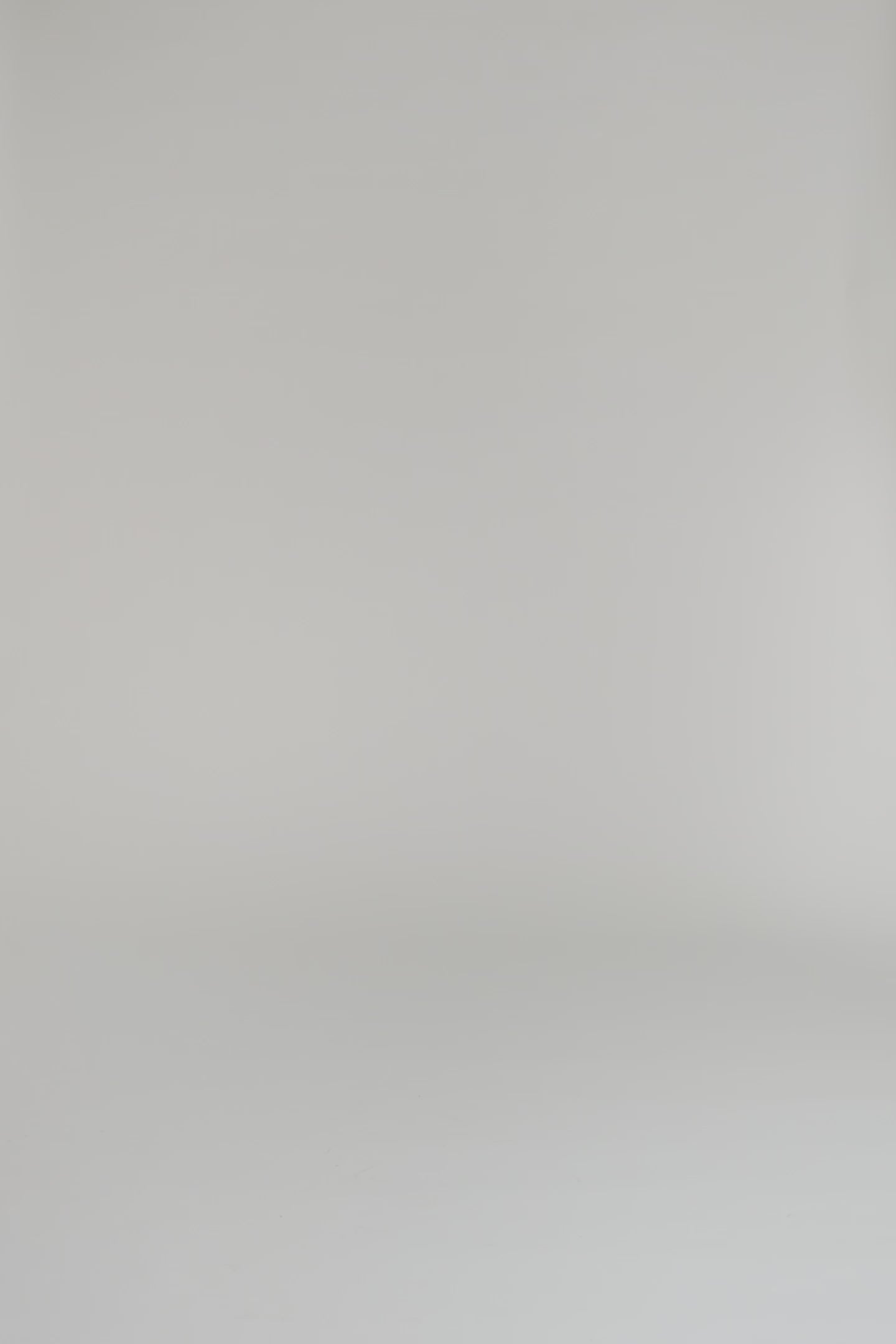 Woman wearing white and navy silk shirt dress with long sleeves