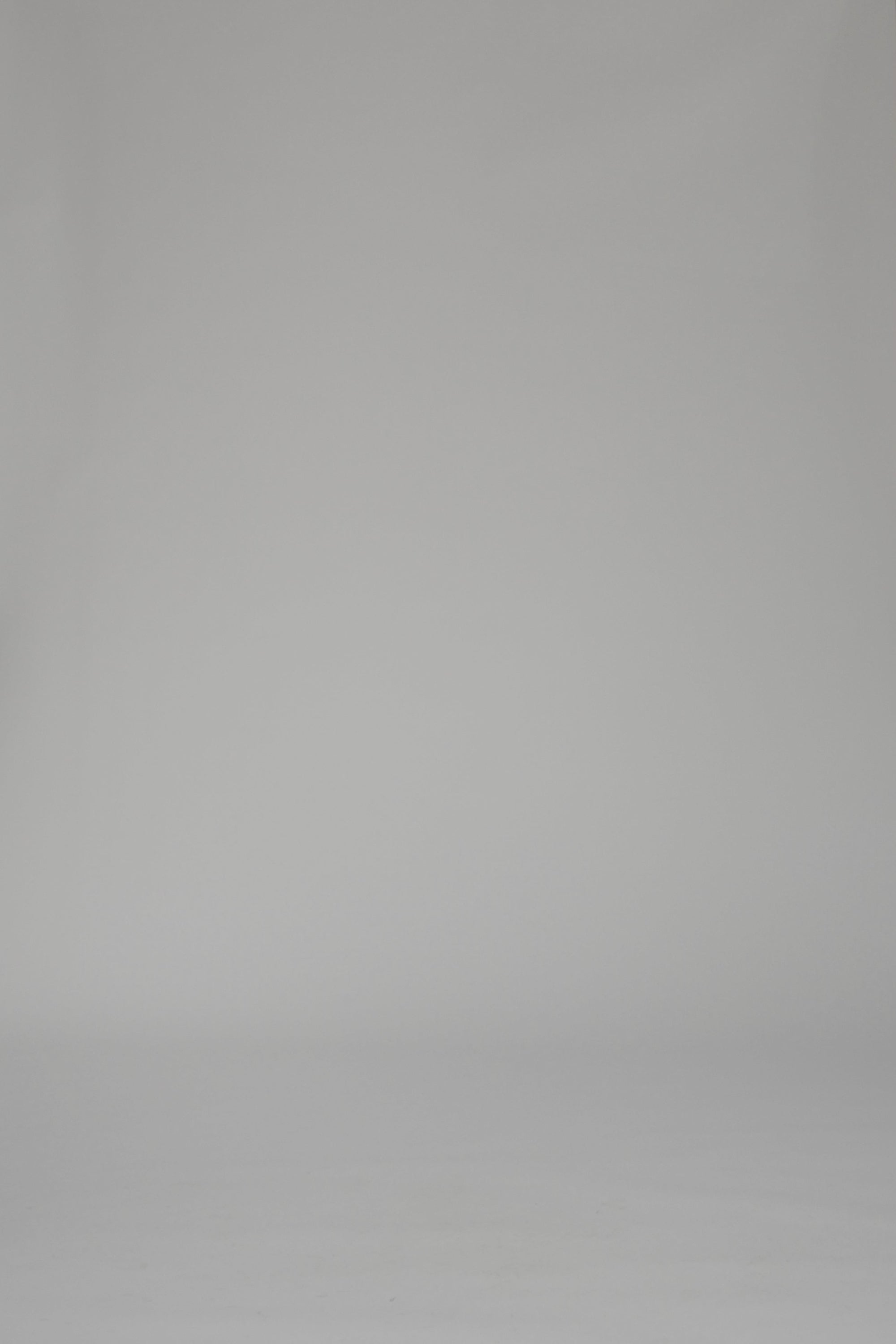 Woman modeling a orange striped dress on a white backdrop
