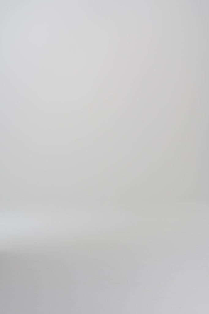 Woman modeling a tan turtleneck in a studio