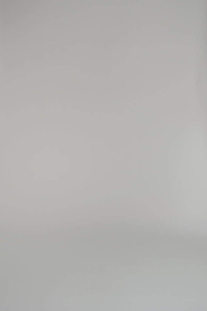 Woman modeling a cobalt blue cashmere polo against a white background 