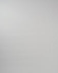 Video of woman walking across a white backdrop wearing a long sleeve pink silk crewneck