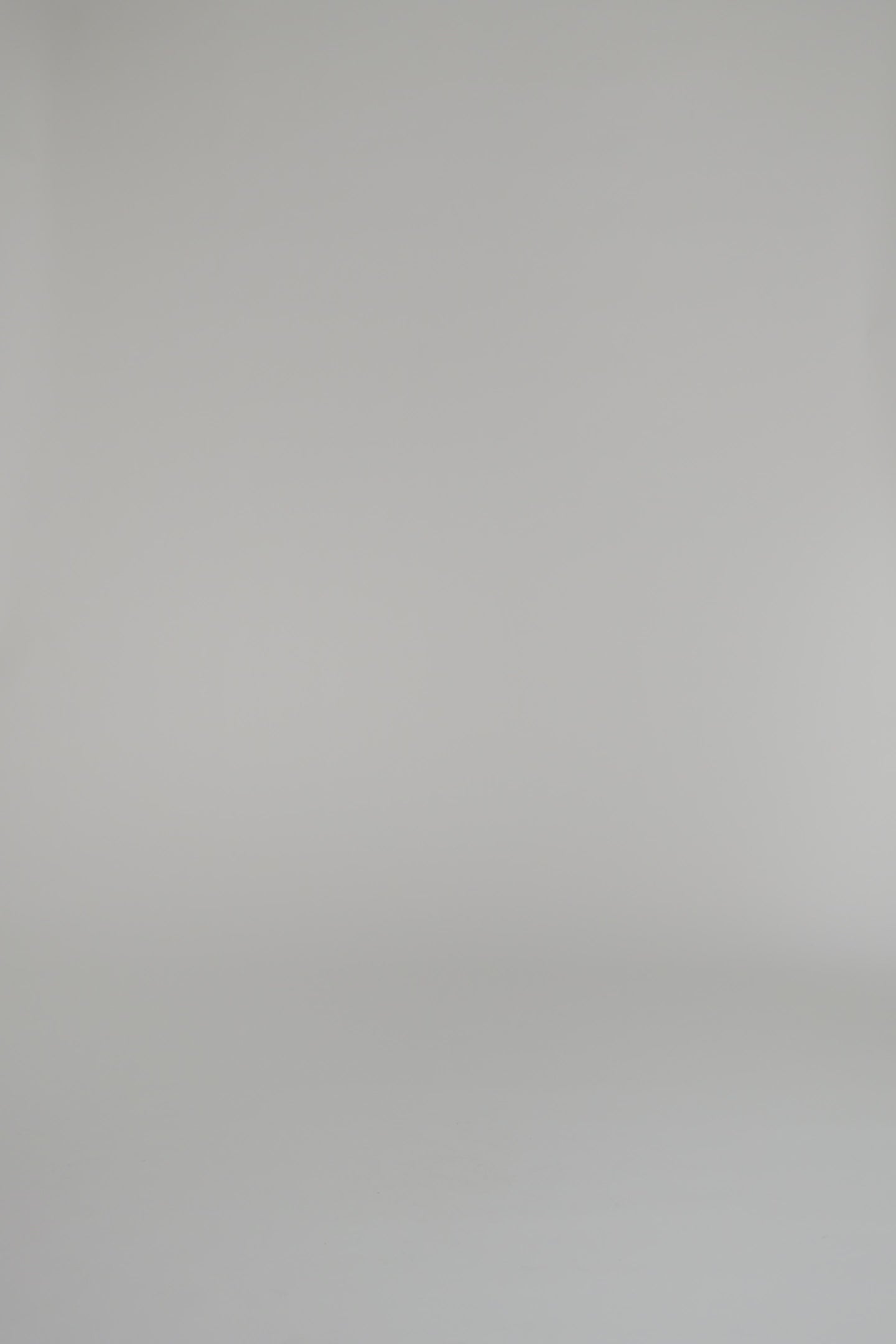 woman wearing a black cashmere sweater against a white backdrop