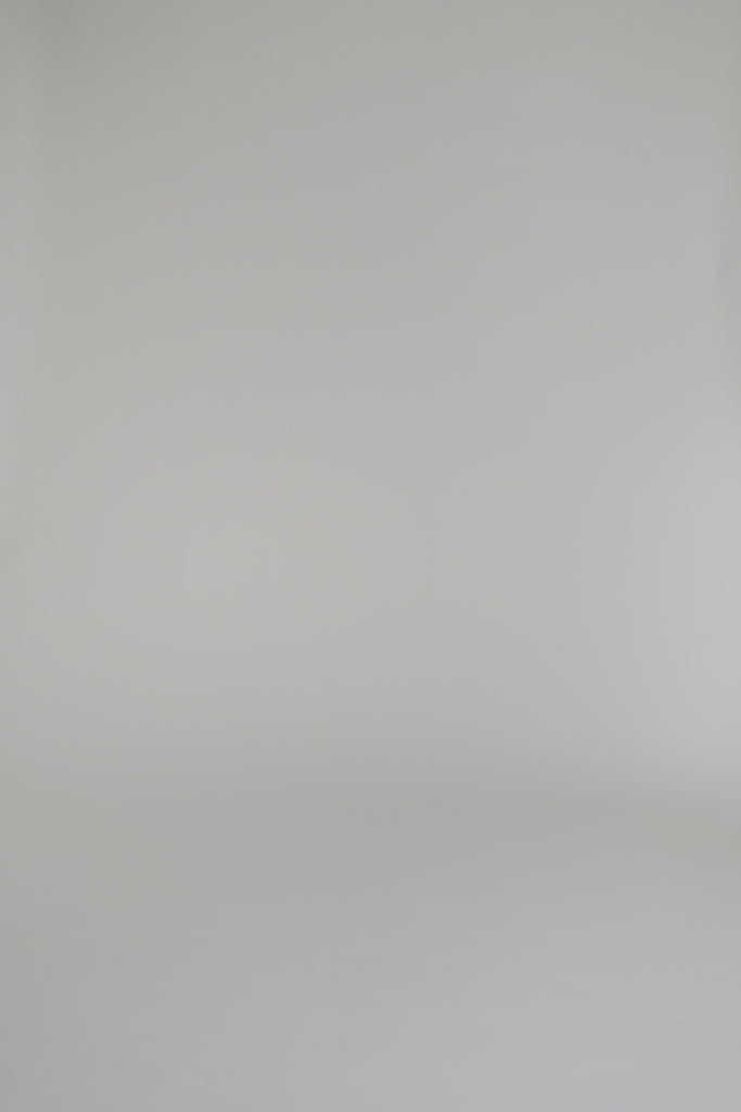 woman wearing a black cashmere sweater against a white backdrop