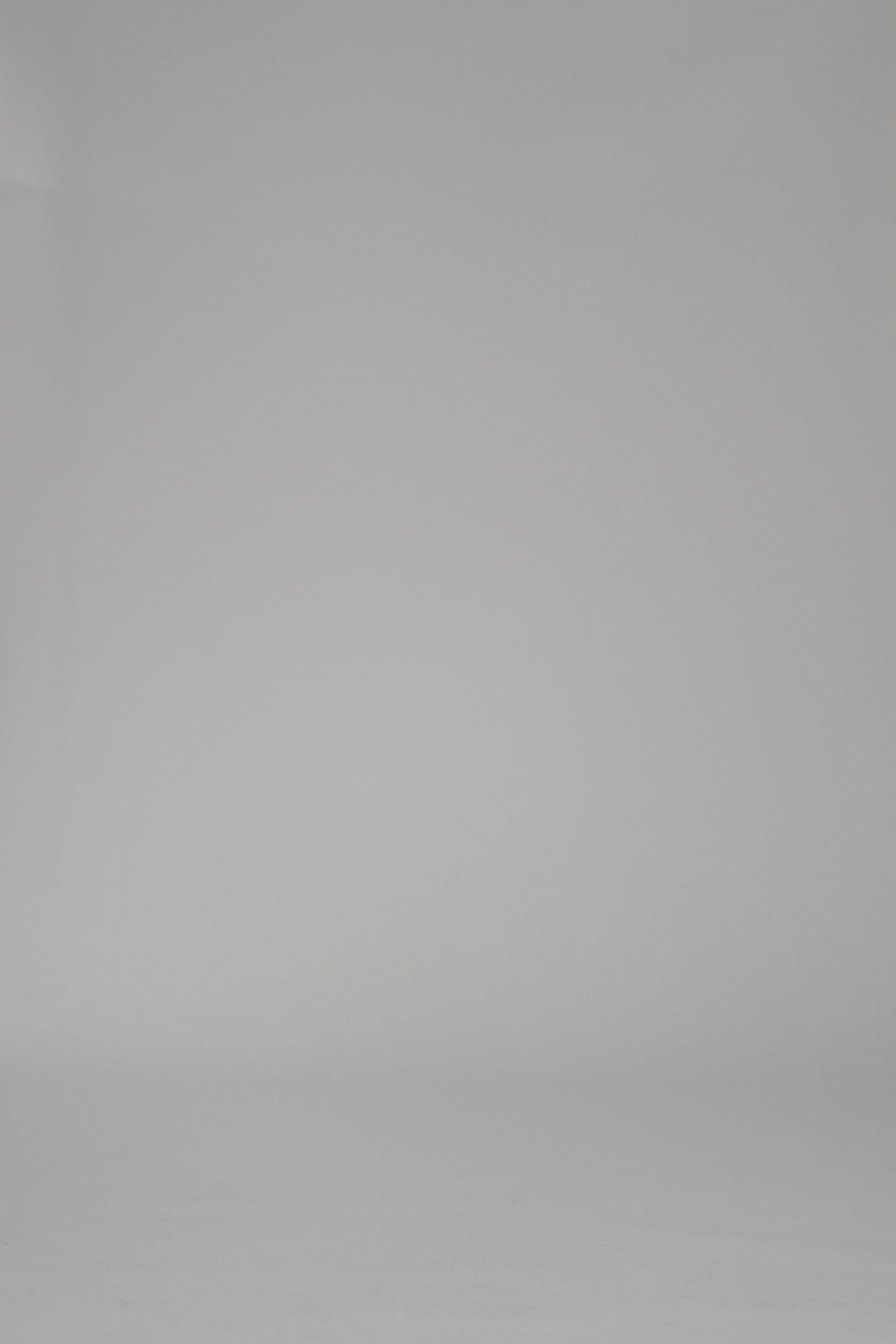Woman wearing a mutli-color striped long sleeve dress on a plain backdrop