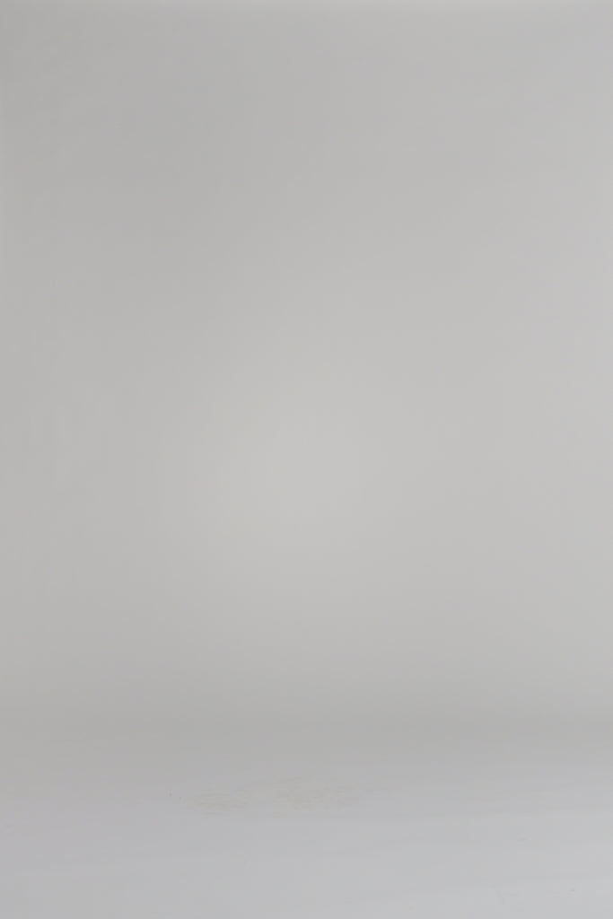 woman wearing a pink sweater on a white backdrop