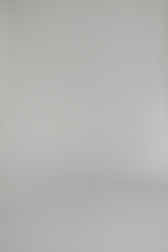 woman modeling a pair of blue pants against a white background