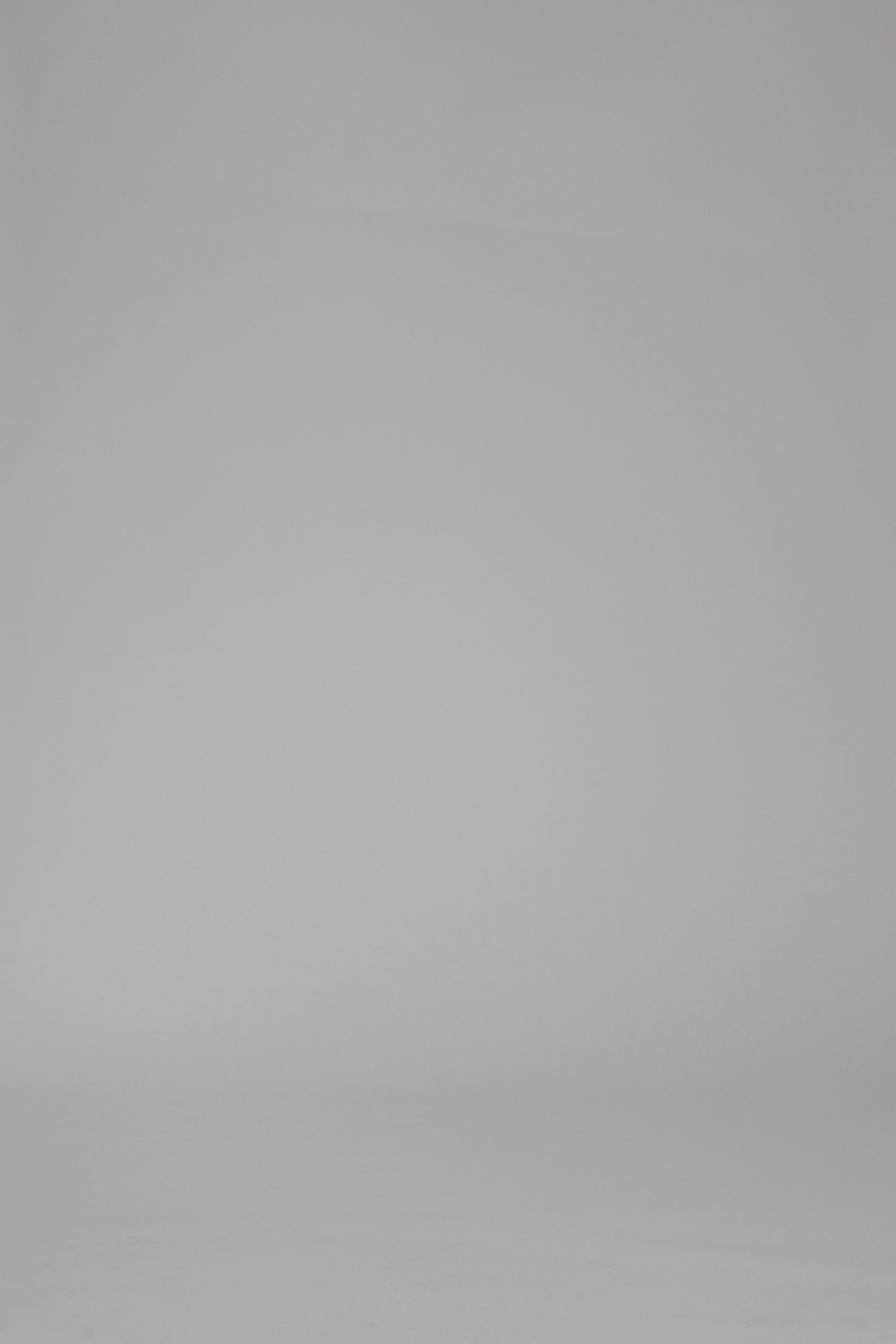 Woman modeling a green and white striped mid-length dress on a white backdrop