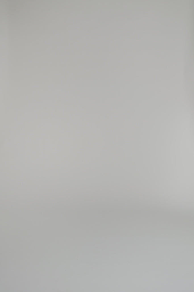 woman modeling blue long sleeve dress wearing heels on a white backdrop