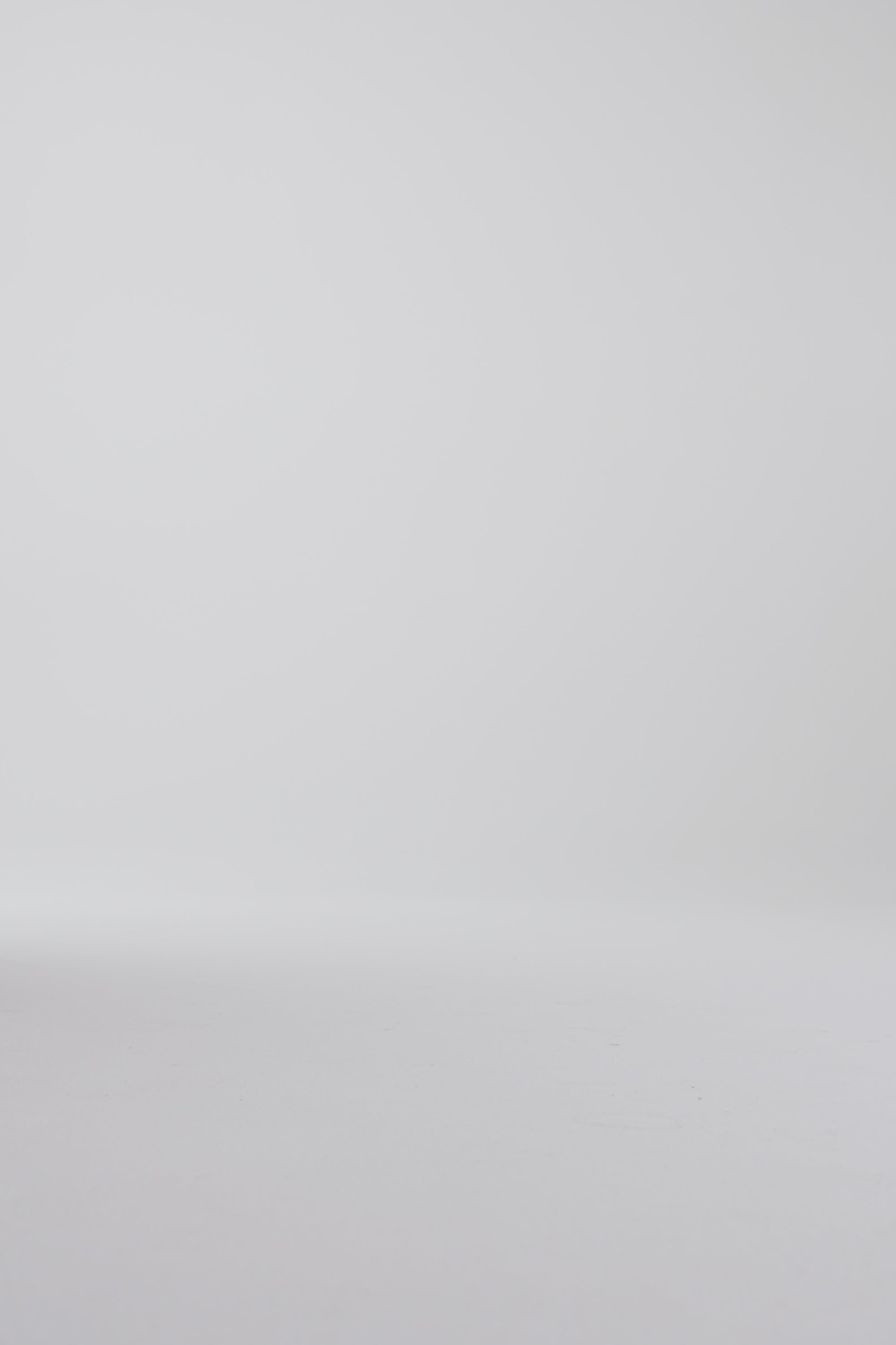 Woman modeling derby shoes on a white backdrop