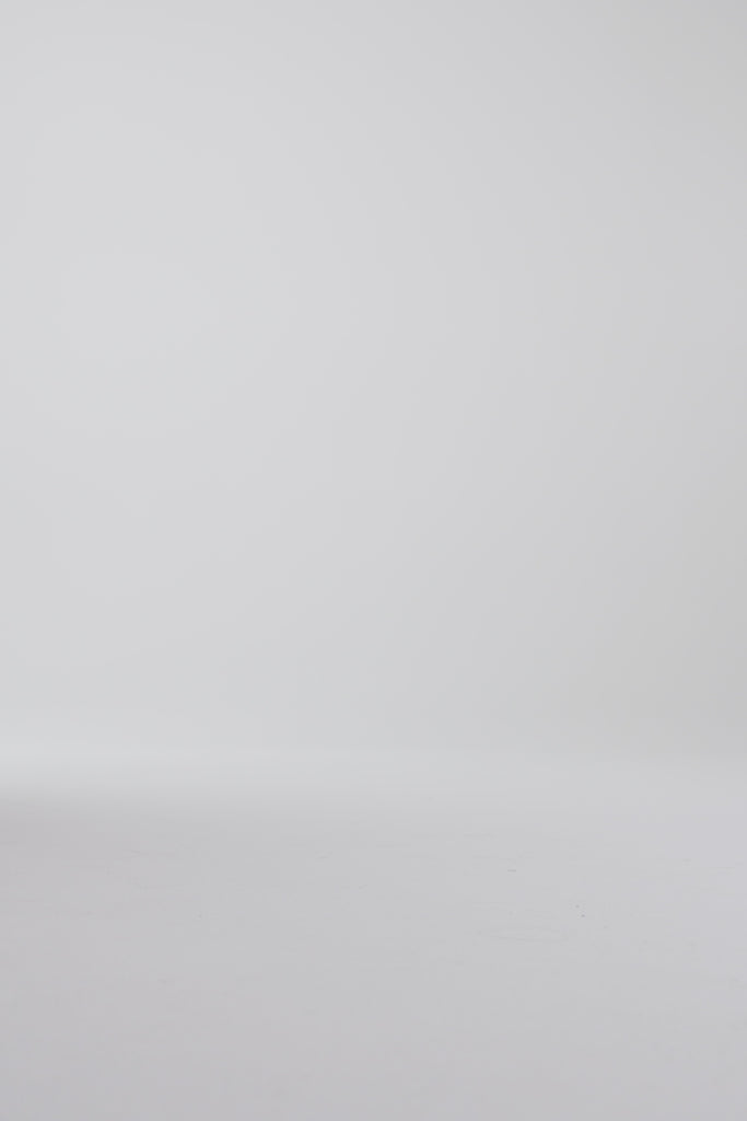 Woman modeling derby shoes on a white backdrop
