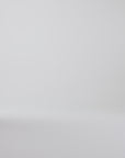 Woman modeling derby shoes on a white backdrop