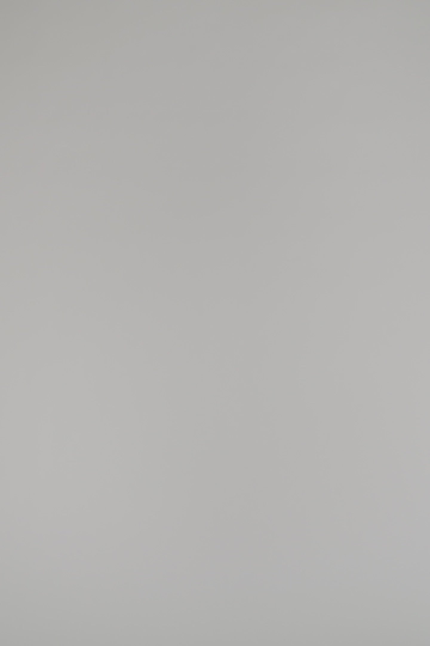 woman modeling red cashmere sweater against a white backdrop