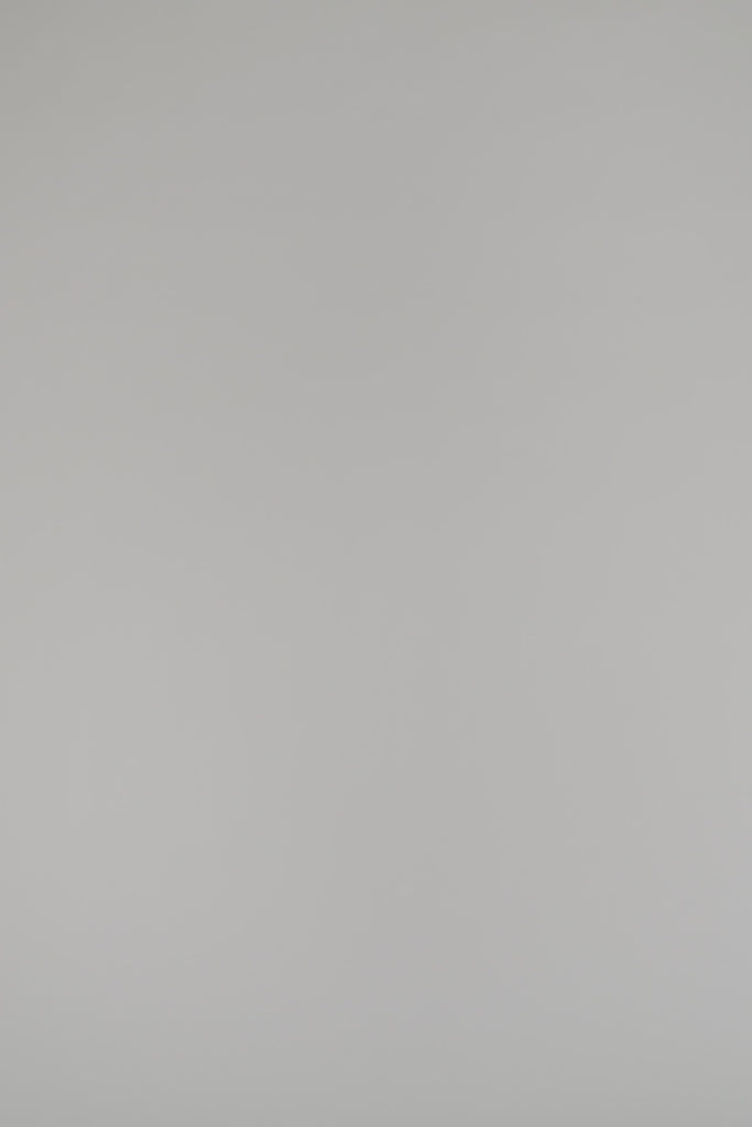 woman modeling red cashmere sweater against a white backdrop