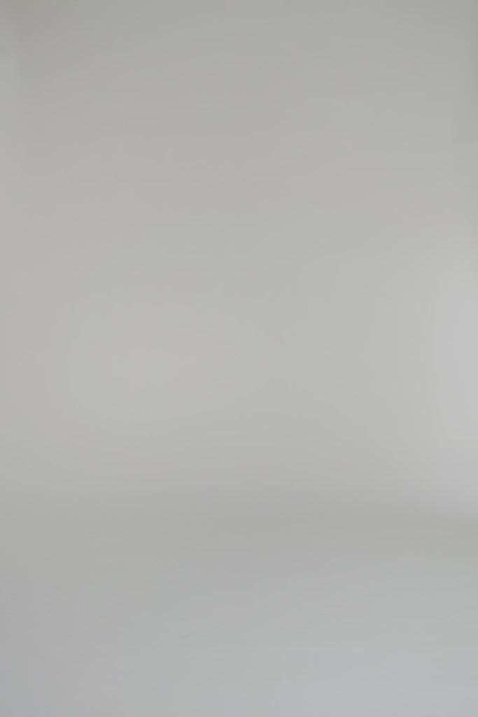 woman modeling floral outfit on a white backdrop